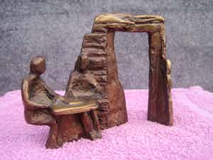 Brons (Onbekend) - Zittend naast de poort. verkocht voor € 35!