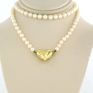 18k gouden hartvormslot bezet met single cut geslepen diamant aan parel collier kopen? Bied vanaf 185!