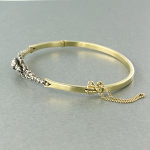 14k gouden scharnierarmband met een zilveren kop bezet met roos diamanten kopen? Bied vanaf 500!