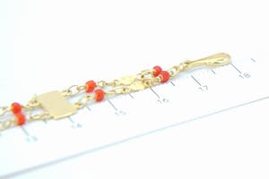 2573 - Surinaams 14 karaat geel-gouden zg. "piet-piet" armband met rode kralen kopen? Bied vanaf 110!