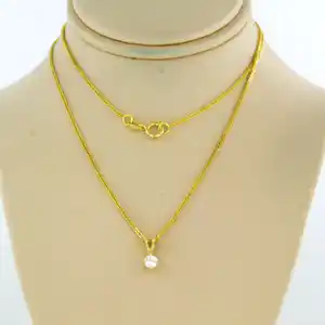 14k gouden collier met een solitair hanger bezet met briljant geslepen diamant verkocht voor € 210!