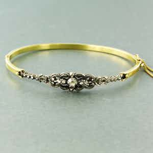 14k gouden scharnierarmband met een zilveren kop bezet met roos diamanten verkocht voor € 500!