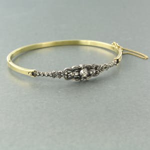 14k gouden scharnierarmband met een zilveren kop bezet met roos diamanten kopen? Bied vanaf 500!
