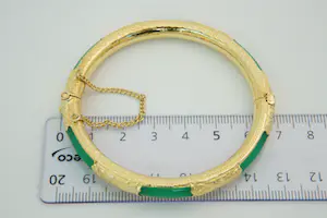 57 - Surinaamse 20Krt geel gouden armband met groene kunststof kern kopen? Bied vanaf 390!