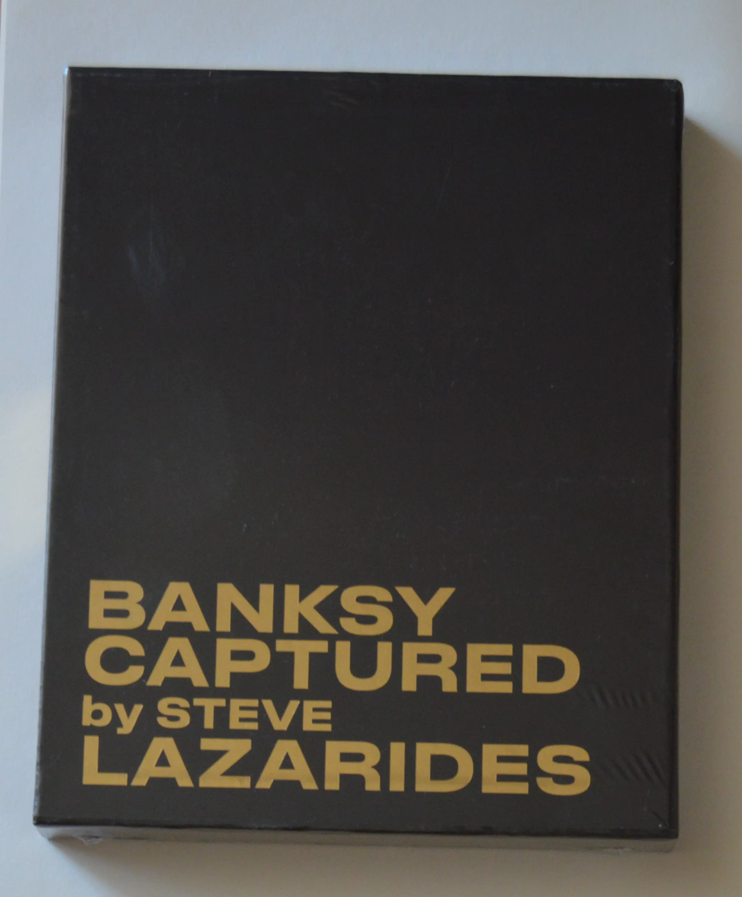 Banksy - en Steve Lazarides; CAPTURED. Black edition. sold