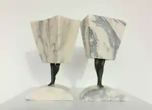Hans Rikken - Pendant: Set van twee sculpturen uit marmer en brons, Man + Vrouw + 2 boeken kaufen? Bieten Sie von 150!