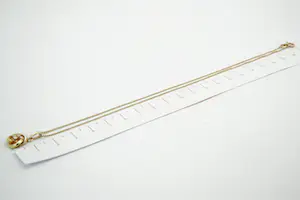 125 - Zeer fijn 14 Krt gouden gourmette collier met opengewerkte knoop hanger kopen? Bied vanaf 85!