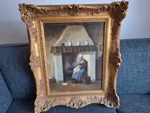 Hendrikus van Langen - Landelijk interieur met vrouw bij het haardvuur met borduurwerk verkocht voor € 150!
