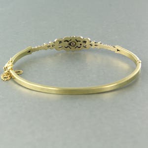 14k gouden scharnierarmband met een zilveren kop bezet met roos diamanten kopen? Bied vanaf 500!